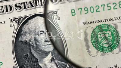 One dollar banknote identification with magnifying glass