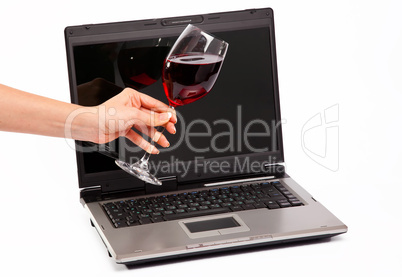 Laptop and glass of red wine