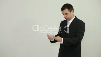 Funny businessman playing game on tablet