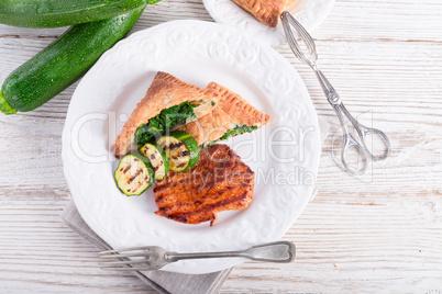 grilled steaks with puff pastry bag and zucchini