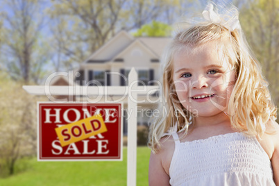 Cute Girl in Yard with Sold For Sale Real Estate Sign and House