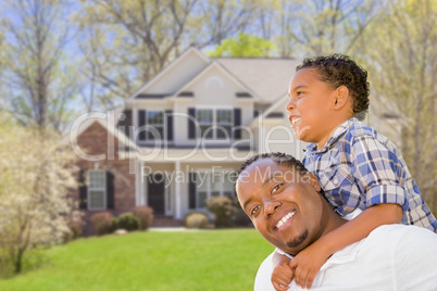 Mixed Race Father and Son In Front of House