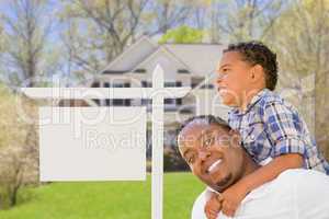 Father and Son In Front of Blank Real Estate Sign and House