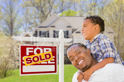 Mixed Race Father and Son In Front of Real Estate Sign and House