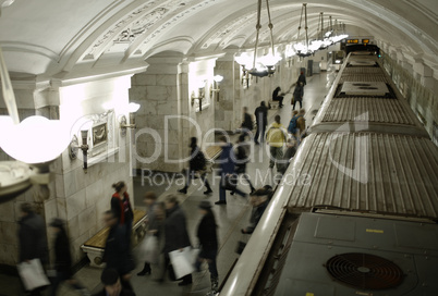 blurred people on subway platform.