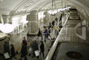 blurred people on subway platform.