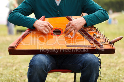 folk musician playing gusli
