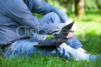 detail of hands and laptop keyboard.