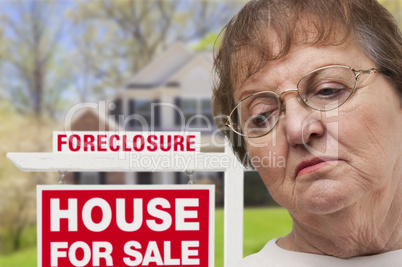 Depressed Senior Woman in Front of Foreclosure Real Estate Sign