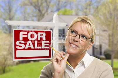 Young Woman in Front of Sold Sign and House