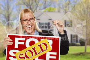 Woman with Sold Sign and Keys in Front of House