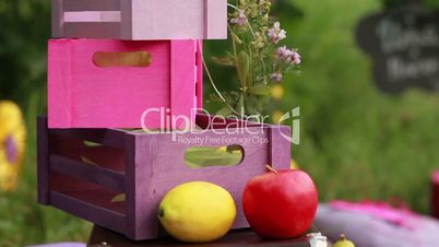 boxes, lemon and apple on the green grass in the park