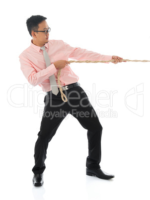 Asian businessman pulling a rope