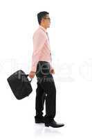Asian businessman walking with briefcase