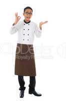 Asian male chef showing copy space and okay hand sign