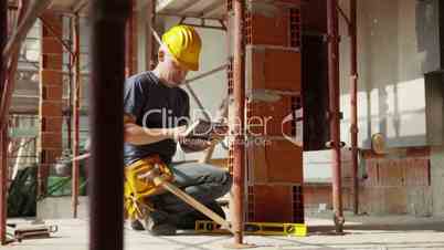 Construction worker and new building, man using digital tablet computer