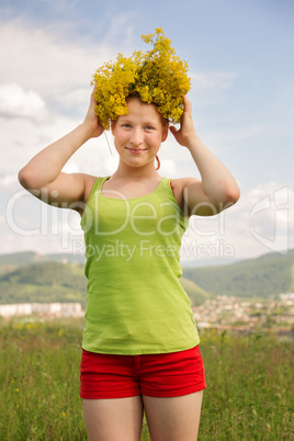 Portrait of the girl in a wreath from flowers