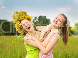 Girlfriends walk and play a meadow