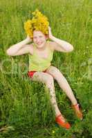 Portrait of the girl in a wreath from flowers