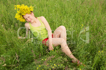 Portrait of the girl in a wreath from flowers