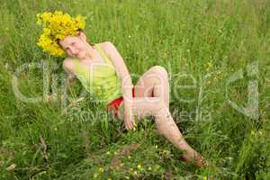 Portrait of the girl in a wreath from flowers