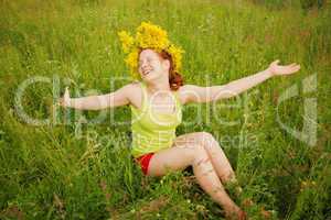 Portrait of the girl in a wreath from flowers