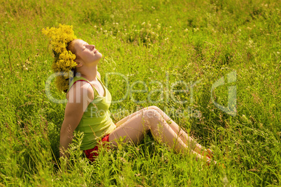 Portrait of the girl in a wreath from flowers