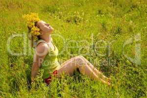 Portrait of the girl in a wreath from flowers