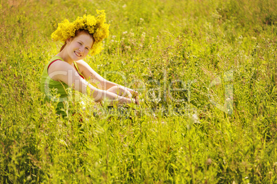 Portrait of the girl in a wreath from flowers