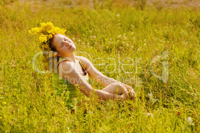 Portrait of the girl in a wreath from flowers