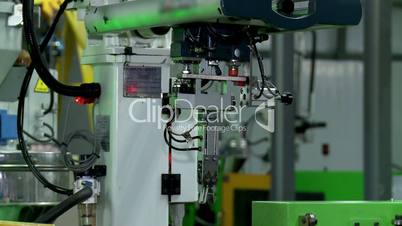 Industrial robots in the factory. Molding plastic products.