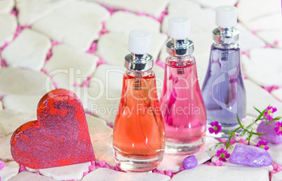 Three bottles of floral fragrance perfume