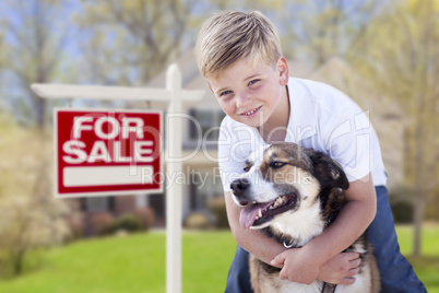 Young Boy and His Dog in Front of For Sale Sign and House