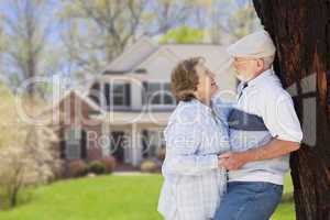 Happy Senior Couple in Front Yard of House