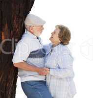 Happy Senior Couple Leaning Against Tree on White