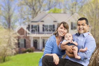 Happy Mixed Race Couple in Front of House