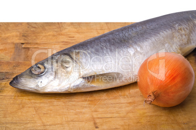 herring with onion on old wooden cutting board