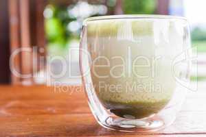 Hot matcha green tea latte serving at coffee shop