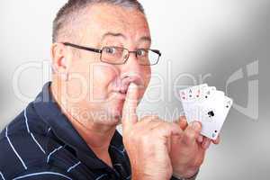 Man with four aces holding finger to mouth