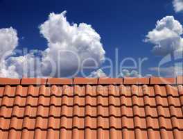 roof tiles against blue sky with clouds