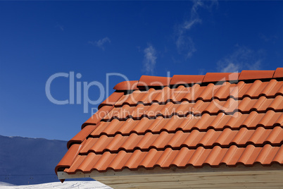 roof tiles against ski slope in nice day