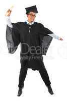 Asian male university student in graduation gown jumping