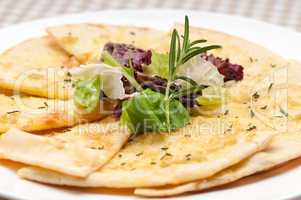 garlic pita bread pizza with salad on top