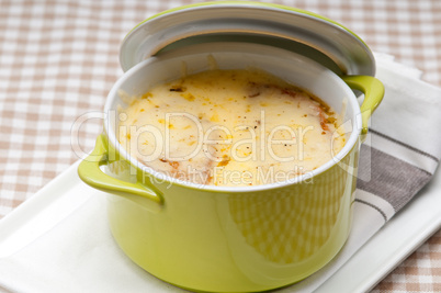 onion soup with melted cheese and bread on top