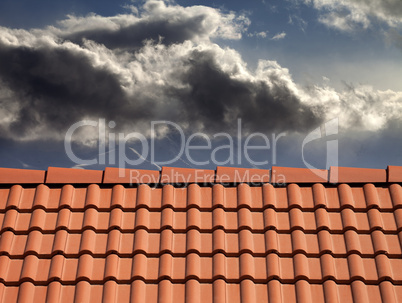 roof tiles and storm sky