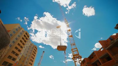 crane lifts building materials for the construction of a multistory building