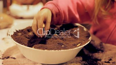Little girl baking a cake shallow DOF