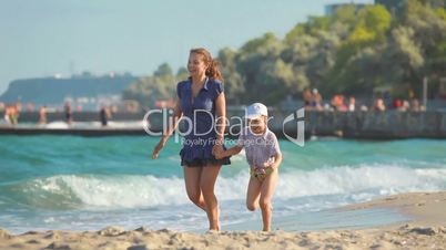 mother and child, happy running on the beach