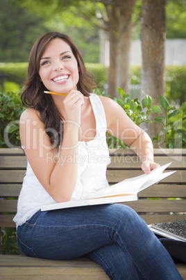 Young Adult Female Student on Bench Outdoors