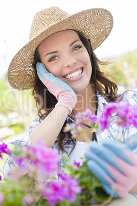 Young Adult Woman Wearing Hat Gardening Outdoors